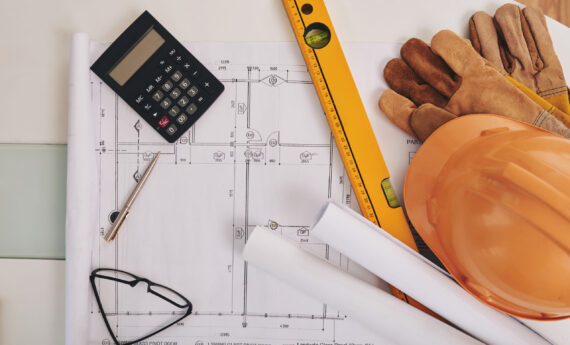 Blueprint, level and belongings of construction engineer